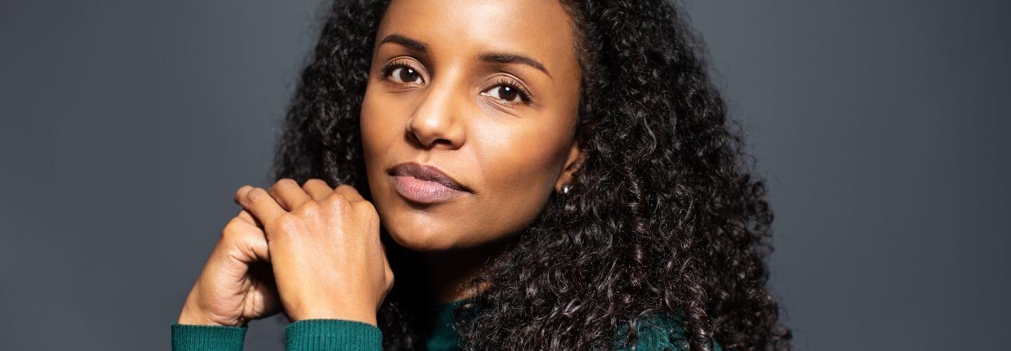 Confident woman representing people pleasing recovery, learning to say no, and setting healthy boundaries in relationships.