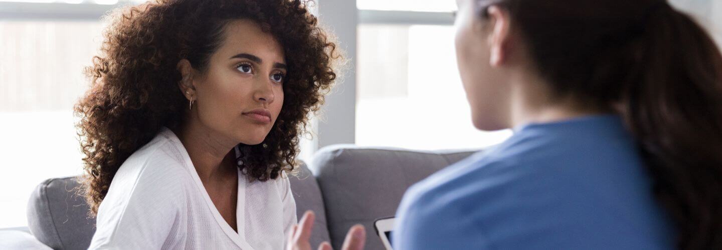 Woman having a serious conversation while setting healthy boundaries in a relationship and learning to say no without guilt.